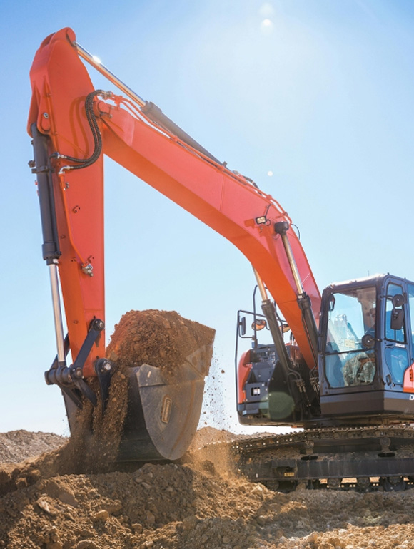 An excavator breaking ground